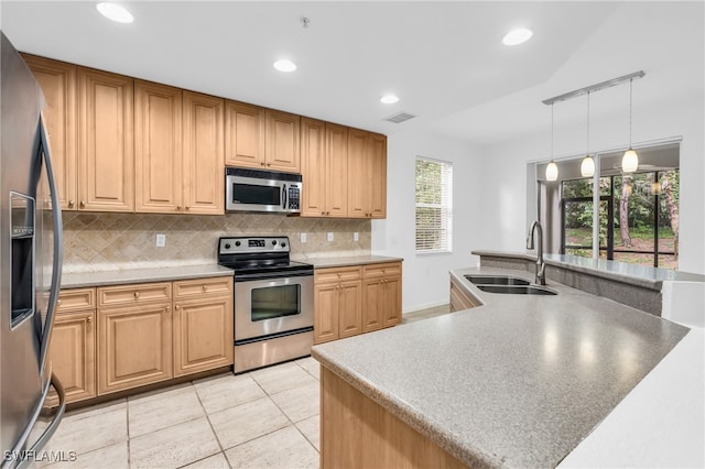 kitchen with backsplash, appliances with stainless steel finishes, a healthy amount of sunlight, and sink