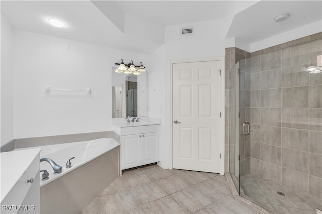 bathroom featuring tile patterned flooring, vanity, and separate shower and tub