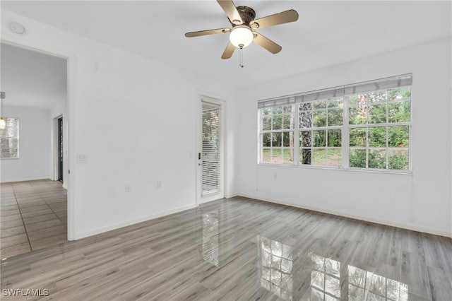 unfurnished room with ceiling fan and light hardwood / wood-style flooring