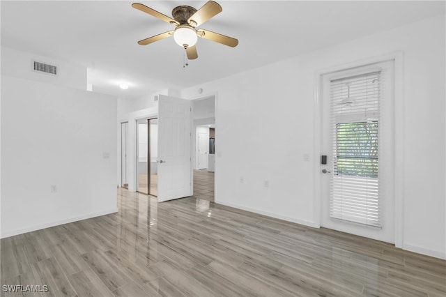 unfurnished bedroom with ceiling fan and light hardwood / wood-style flooring