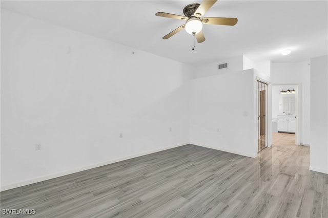 empty room with light hardwood / wood-style floors and ceiling fan