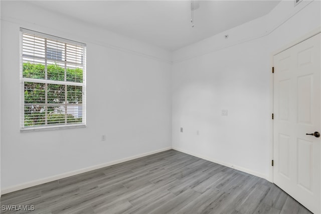 empty room featuring ceiling fan and hardwood / wood-style flooring