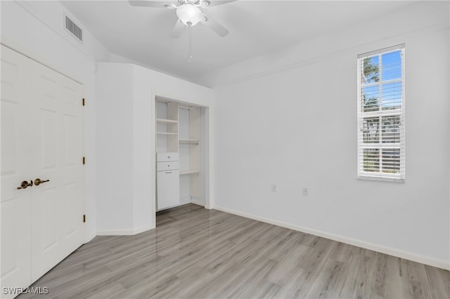 unfurnished bedroom with multiple windows, ceiling fan, and light hardwood / wood-style flooring