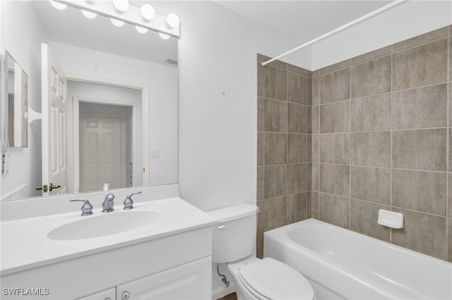 full bathroom with tiled shower / bath combo, vanity, and toilet