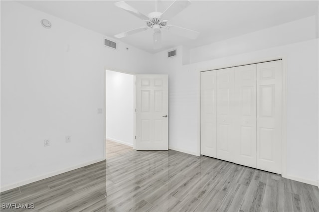 unfurnished bedroom with ceiling fan, a closet, and light hardwood / wood-style floors