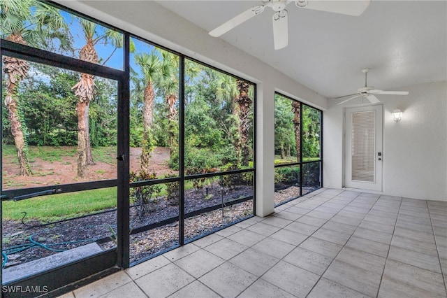 unfurnished sunroom featuring ceiling fan