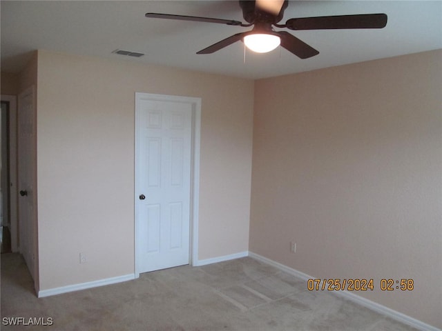 unfurnished bedroom featuring light carpet and ceiling fan