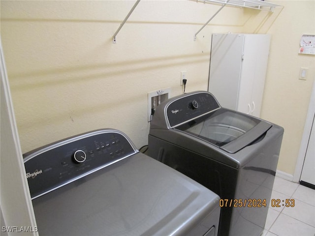 washroom featuring washing machine and clothes dryer and light tile patterned floors