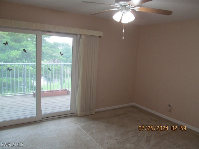 carpeted spare room with ceiling fan