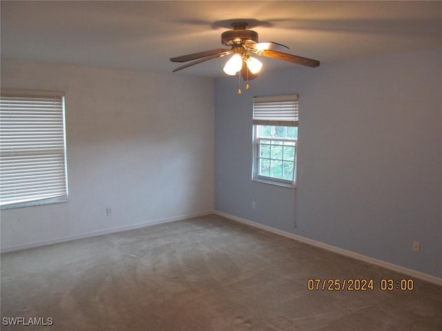 spare room featuring carpet and ceiling fan