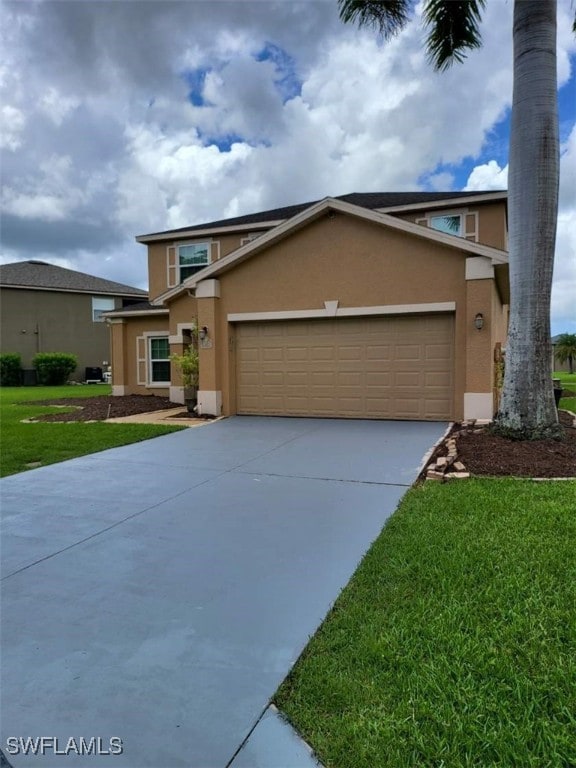 view of property featuring a front yard and a garage