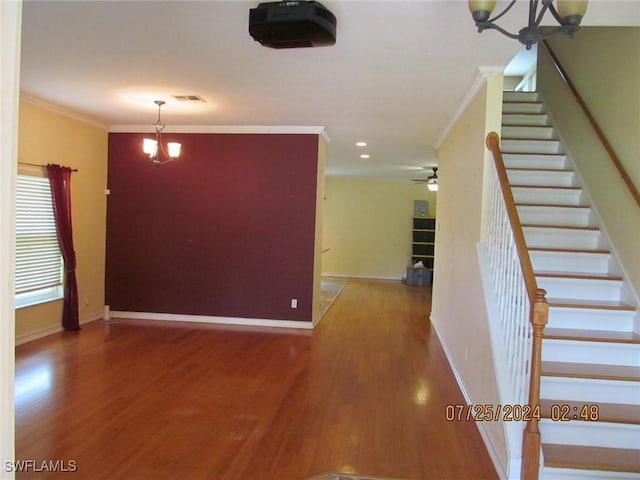 13520 Cypress Head Dr, Fort Myers, FL 33913 - stairway featuring a chandelier, ornamental molding, wood finished floors, a ceiling fan, and baseboards