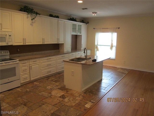 kitchen featuring white appliances, a center island with sink, white cabinetry, and crown molding