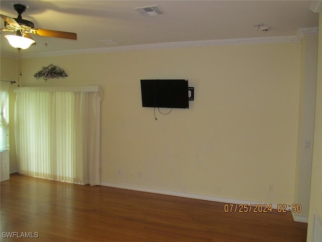 empty room with ceiling fan, ornamental molding, and wood-type flooring