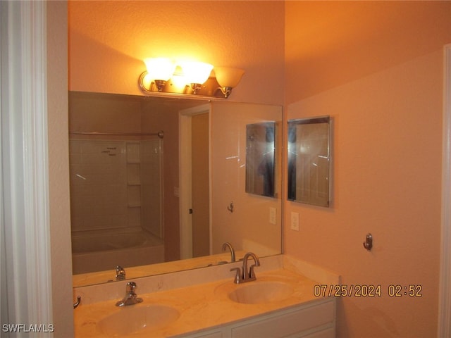 bathroom with vanity and tiled shower / bath combo