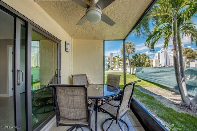 sunroom / solarium featuring ceiling fan