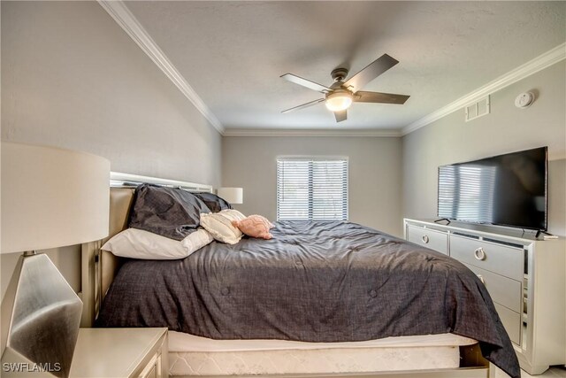 bedroom with ornamental molding and ceiling fan