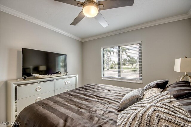 bedroom with ceiling fan and ornamental molding