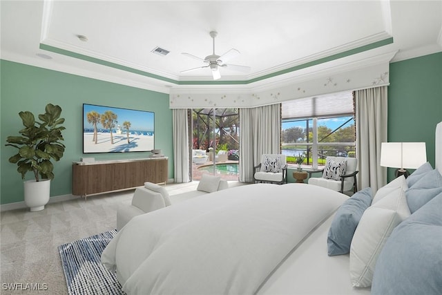 carpeted bedroom with ceiling fan, ornamental molding, and a tray ceiling