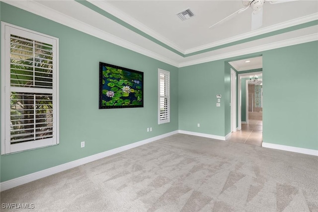 carpeted spare room featuring ornamental molding and ceiling fan