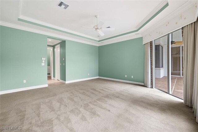 unfurnished bedroom with a raised ceiling, crown molding, and light colored carpet