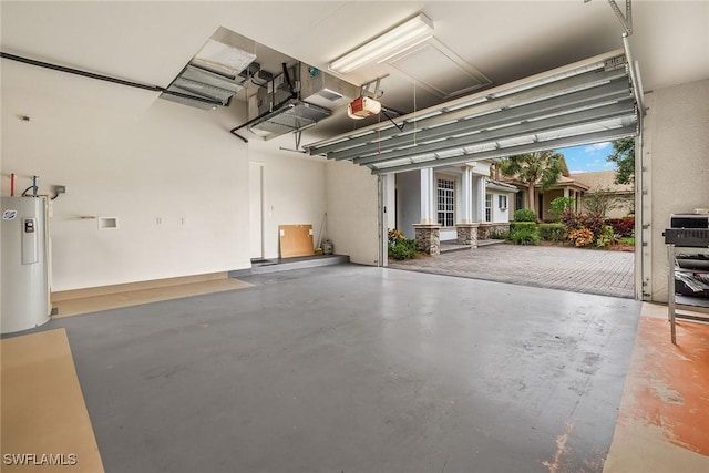 garage featuring a garage door opener and electric water heater