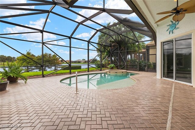 view of swimming pool featuring an in ground hot tub, ceiling fan, glass enclosure, and a patio