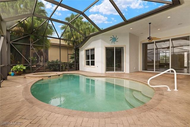 view of pool featuring a lanai, a patio area, and an in ground hot tub