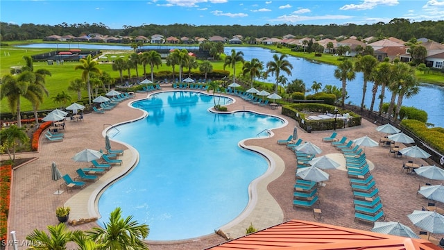 view of pool with a patio and a water view