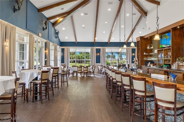 dining area with beamed ceiling, high vaulted ceiling, bar, and dark hardwood / wood-style flooring