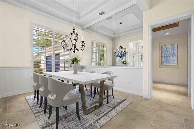 tiled dining area with crown molding, a tray ceiling, and a notable chandelier