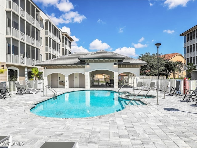 view of pool featuring a community hot tub, a patio area, and a gazebo