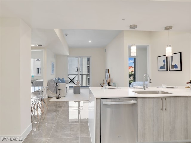 kitchen with pendant lighting, stainless steel dishwasher, plenty of natural light, and sink