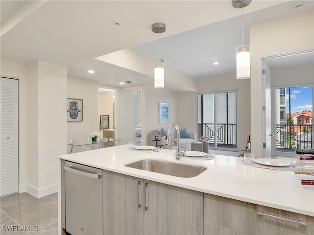 kitchen with dishwasher, pendant lighting, light tile patterned flooring, and sink