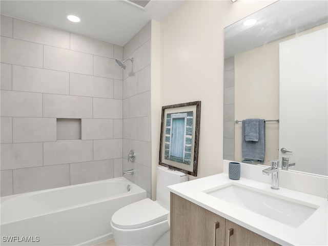 full bathroom with vanity, toilet, and tiled shower / bath