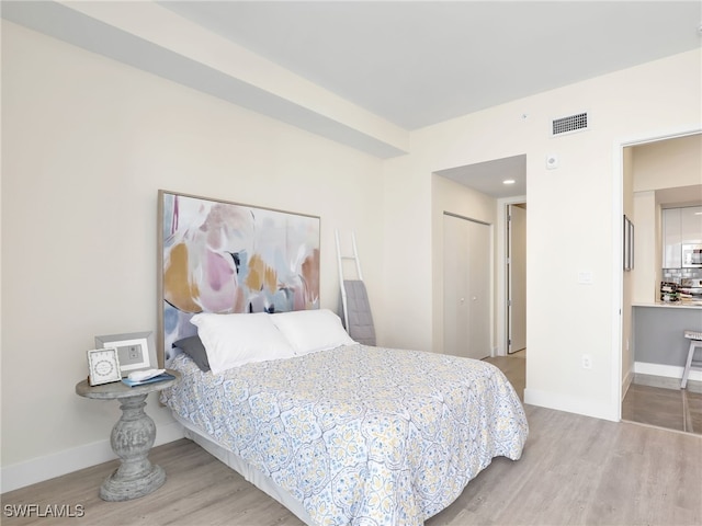 bedroom featuring light hardwood / wood-style flooring and a closet