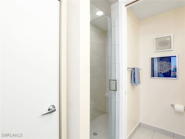 bathroom with tile patterned flooring and a shower with door