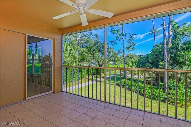 unfurnished sunroom featuring ceiling fan