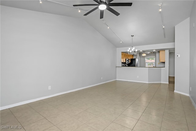 unfurnished living room featuring ceiling fan with notable chandelier, light tile patterned floors, lofted ceiling, and rail lighting