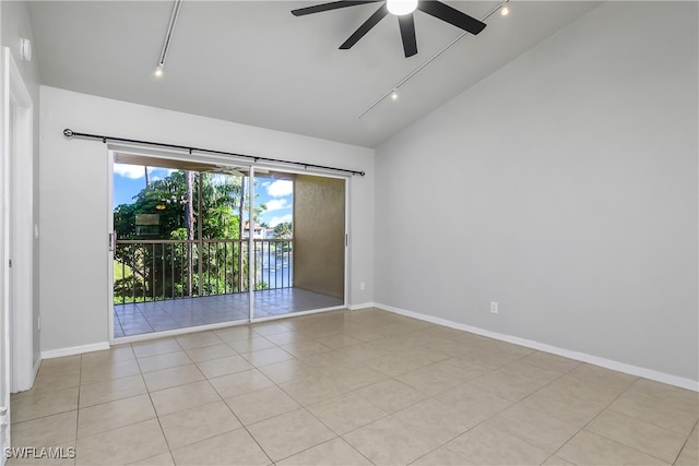 spare room featuring vaulted ceiling, ceiling fan, track lighting, and light tile patterned floors