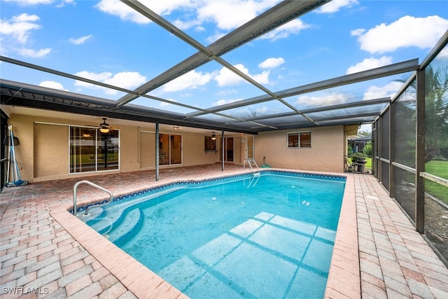 view of pool featuring a lanai, ceiling fan, and a patio area