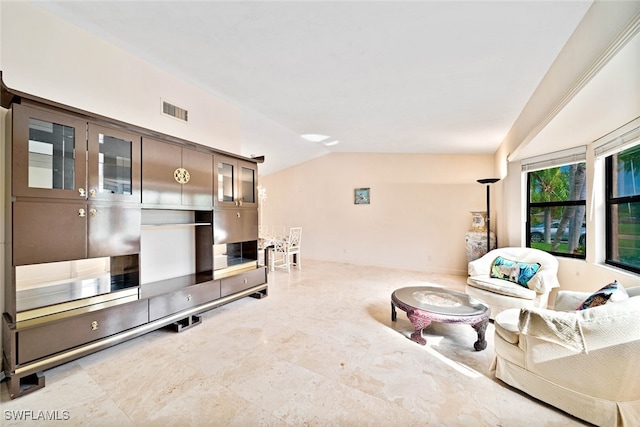 living room featuring lofted ceiling