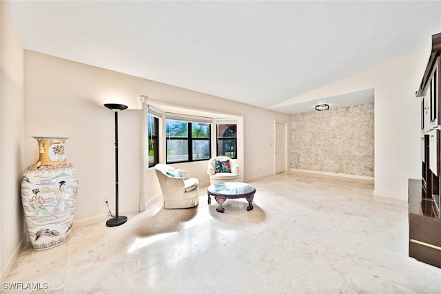 sitting room with lofted ceiling