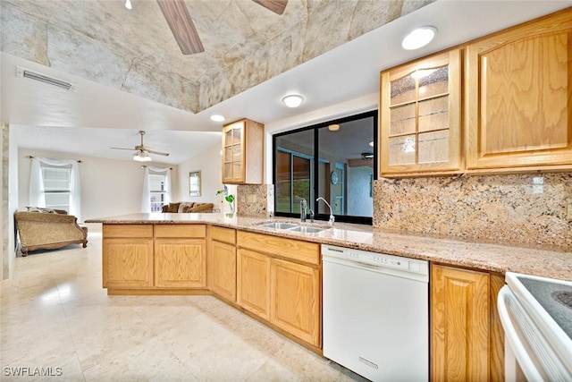 kitchen with ceiling fan, kitchen peninsula, sink, white appliances, and decorative backsplash