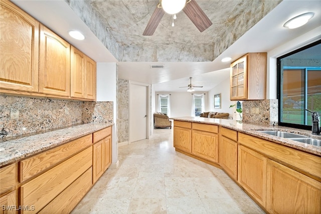 kitchen featuring decorative backsplash, light brown cabinets, ceiling fan, and sink