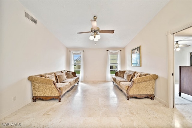 living room with ceiling fan and vaulted ceiling