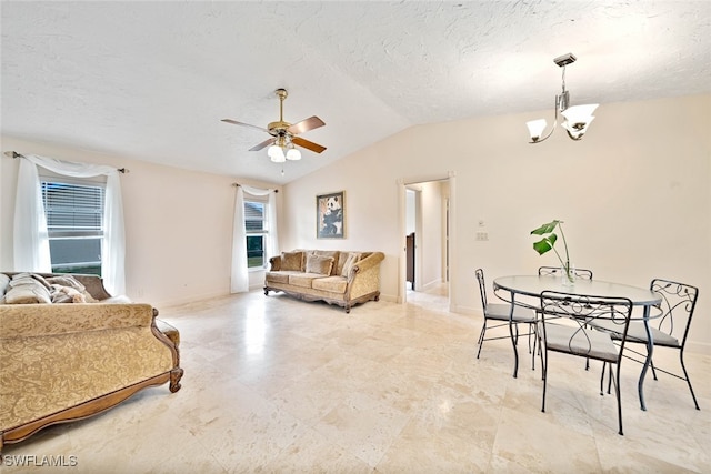 living room with ceiling fan with notable chandelier, vaulted ceiling, and a textured ceiling