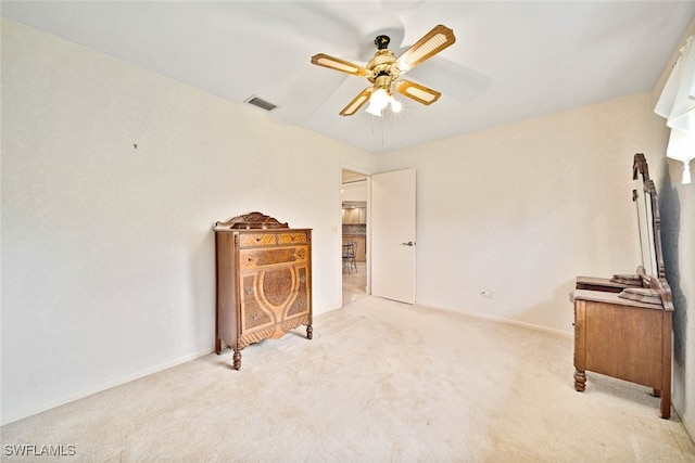 interior space featuring light carpet and ceiling fan