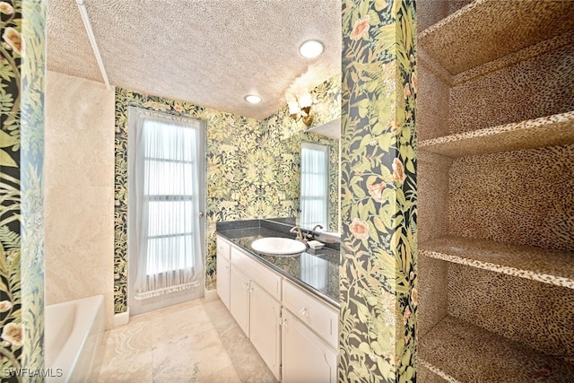 bathroom featuring vanity, shower with separate bathtub, and a textured ceiling