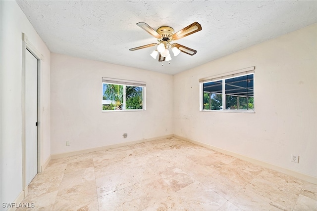 unfurnished bedroom with a textured ceiling and ceiling fan